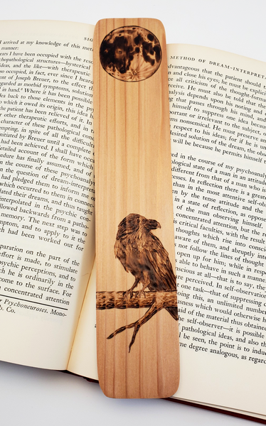 Wooden Bookmark featuring a raven on a branch with a full moon above it.